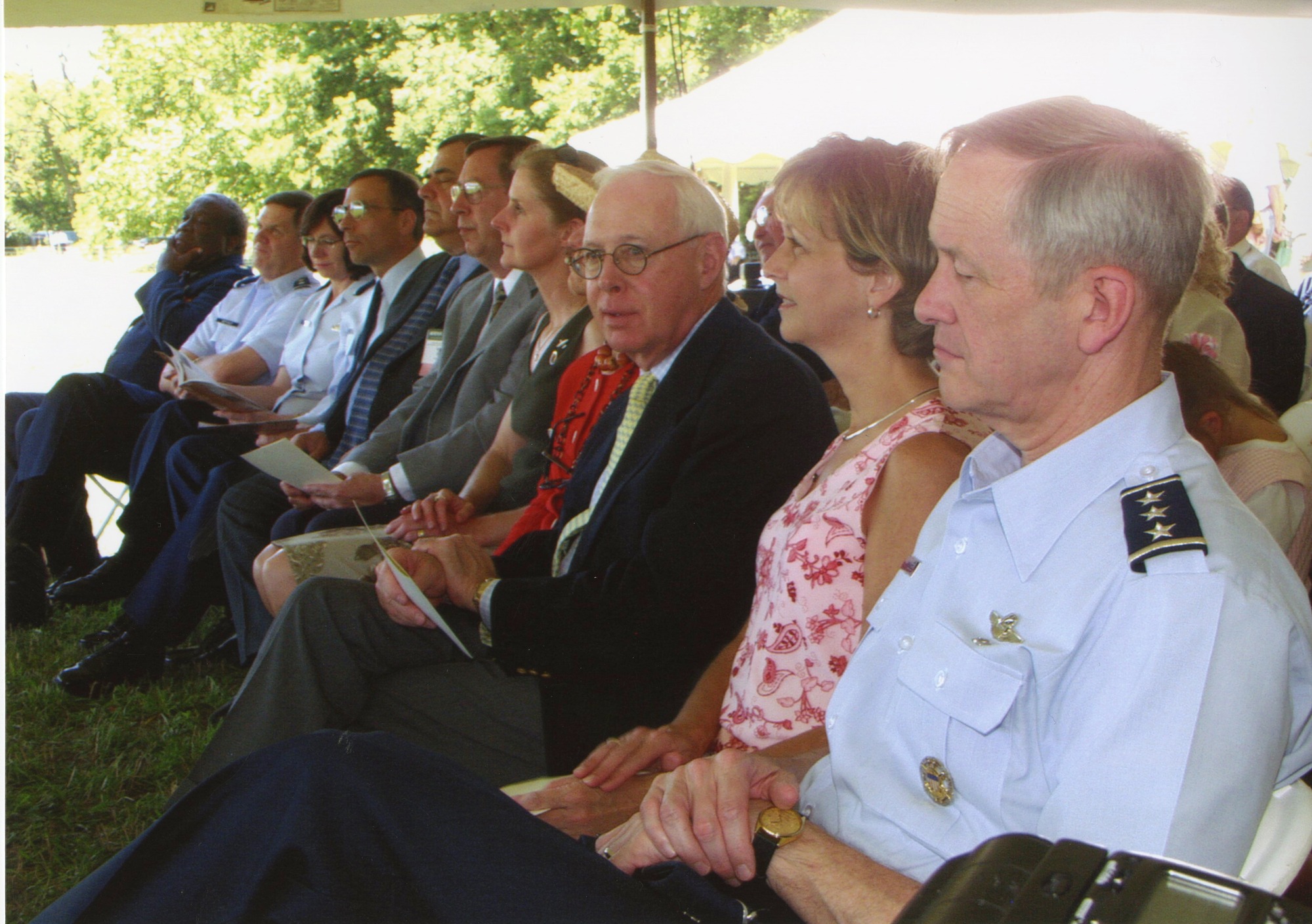 A crowd sitting under a tent