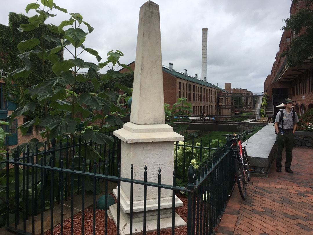 A marble obelisk surrounded by a small metal fence