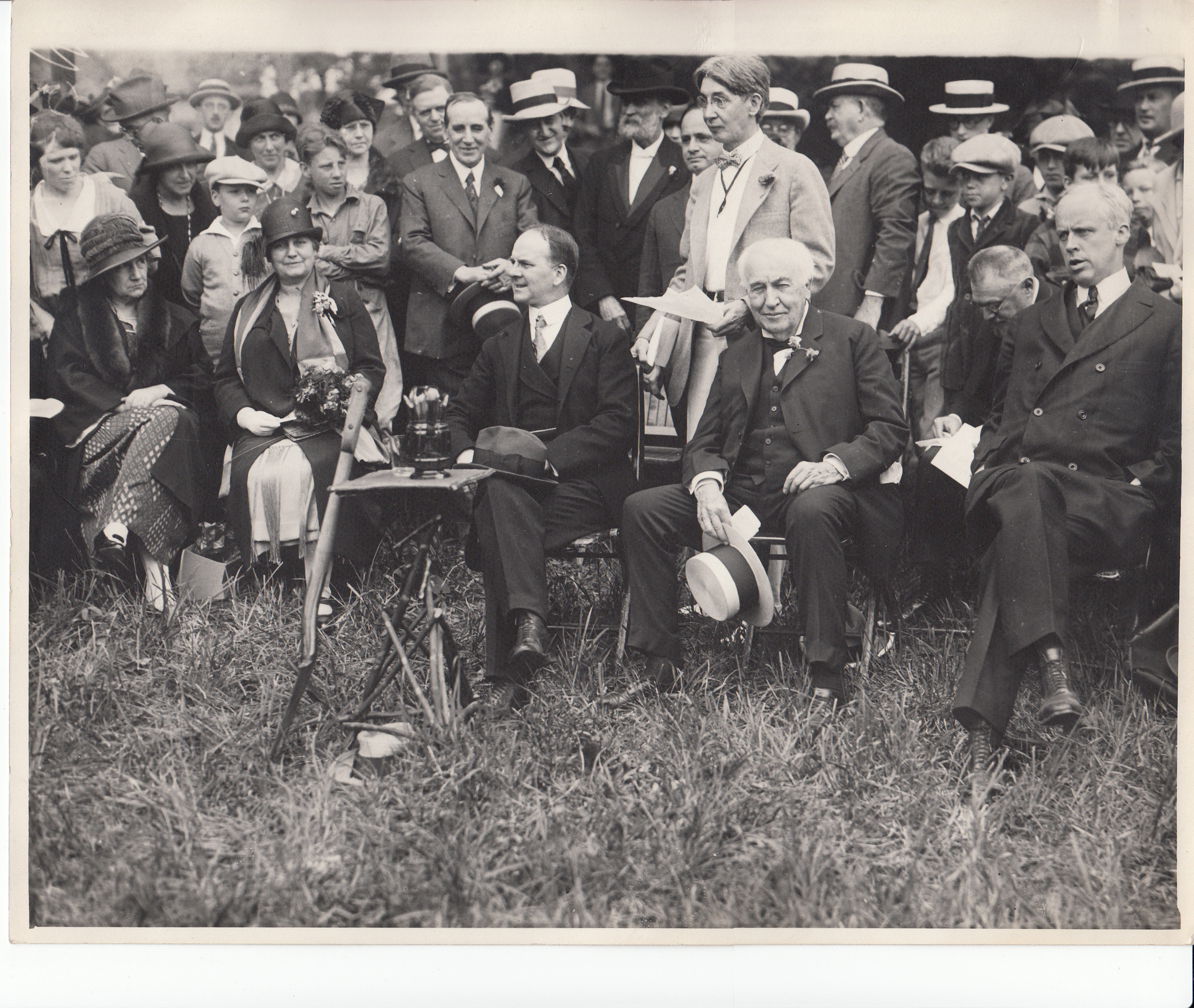 Mina Edison and Thomas Edison sitting with group on lawn.