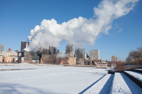A large frozen river runs through a downtown area.