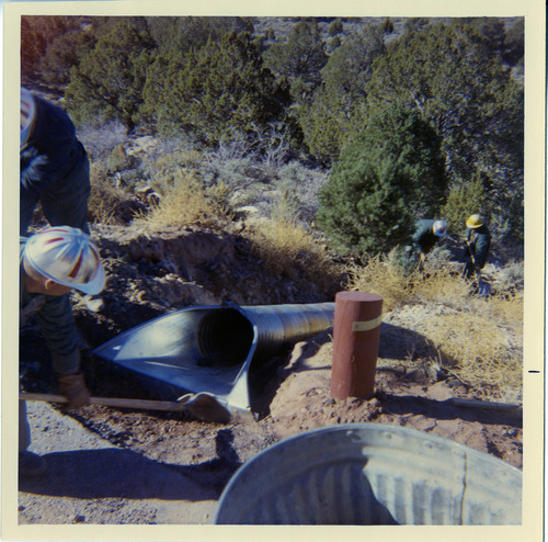 Men working to install a drain piper along the Kolob Canyon Road.