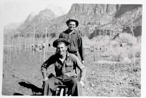 Two Civilian Conservation Corps (CCC) men riding in wheel barrow near the South Entrance.