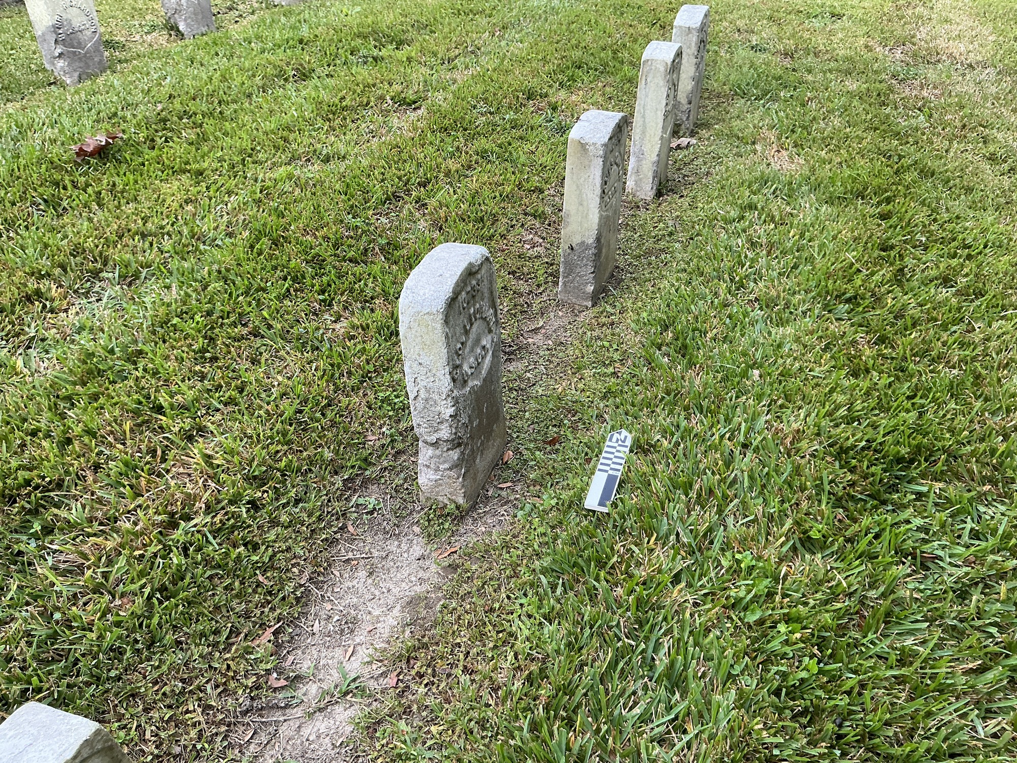 Extra image of historic upright marble headstone with recessed shield face.