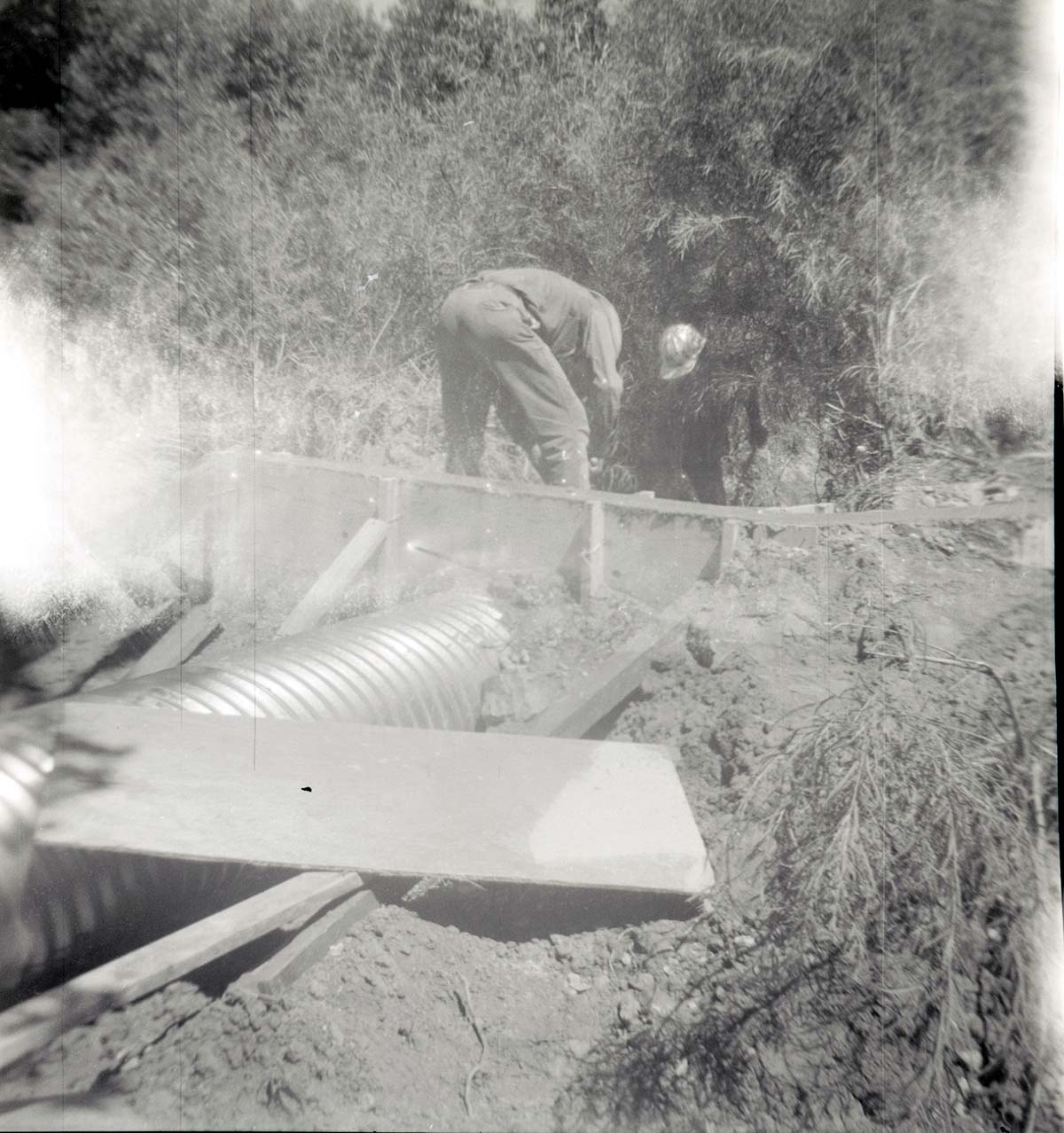 Park personnel installing a culvert/drainage pipe in location in Zion.
