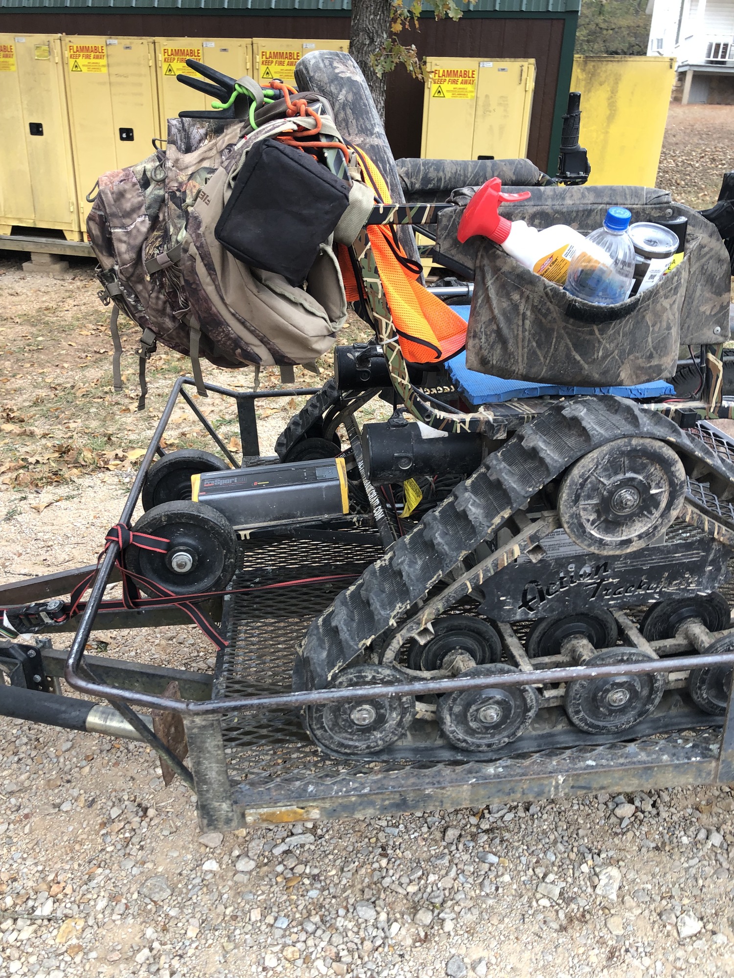 A close-up of a powered mobility device with tracks loaded with hunting gear. 
