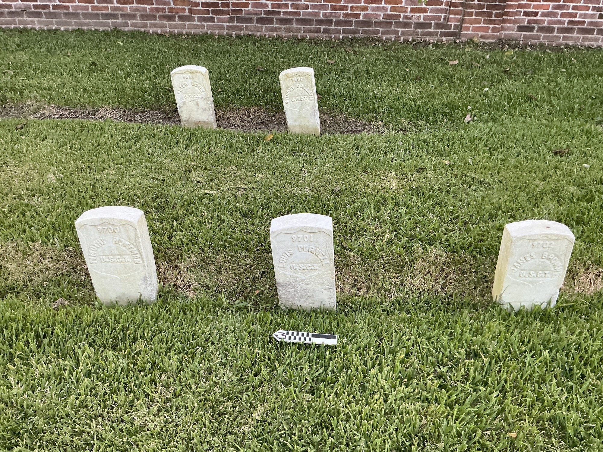 Extra image of historic upright marble headstone with recessed shield with recessed lettering face.