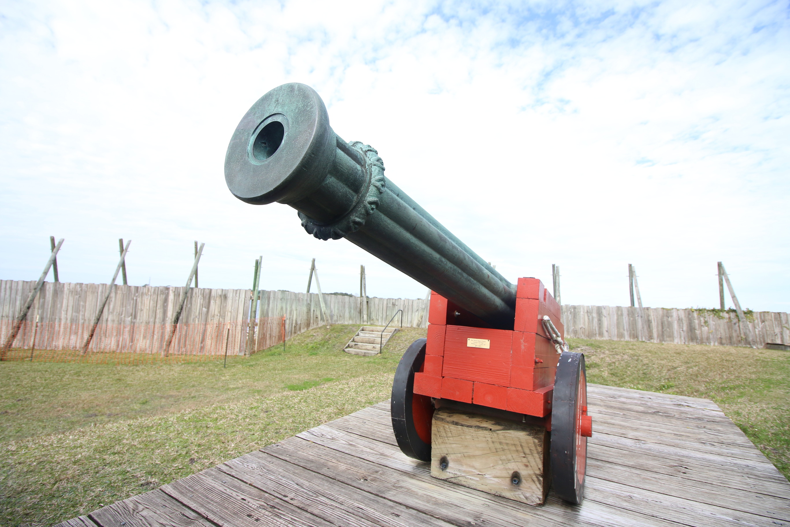 a cannon faces to the left with a red cannon carriage 