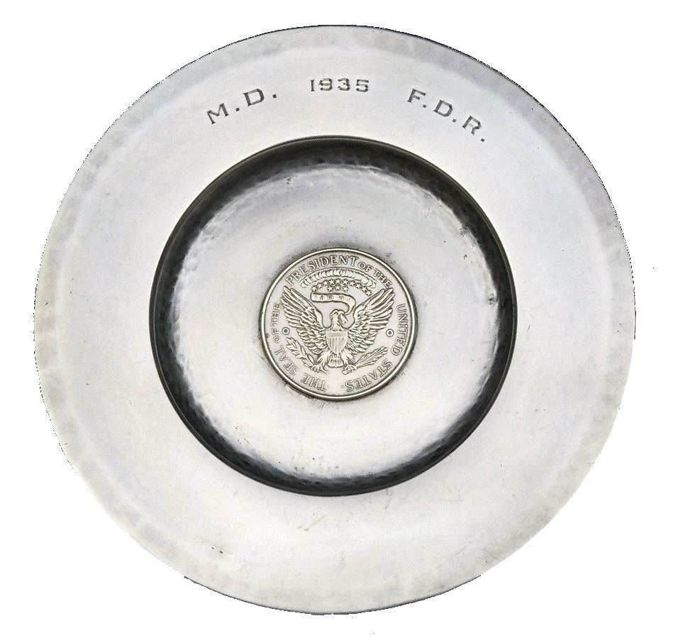 A small plate with a medalian featuring an eagle. It is engraved on the rim "M.D. 1935 F.D.R."