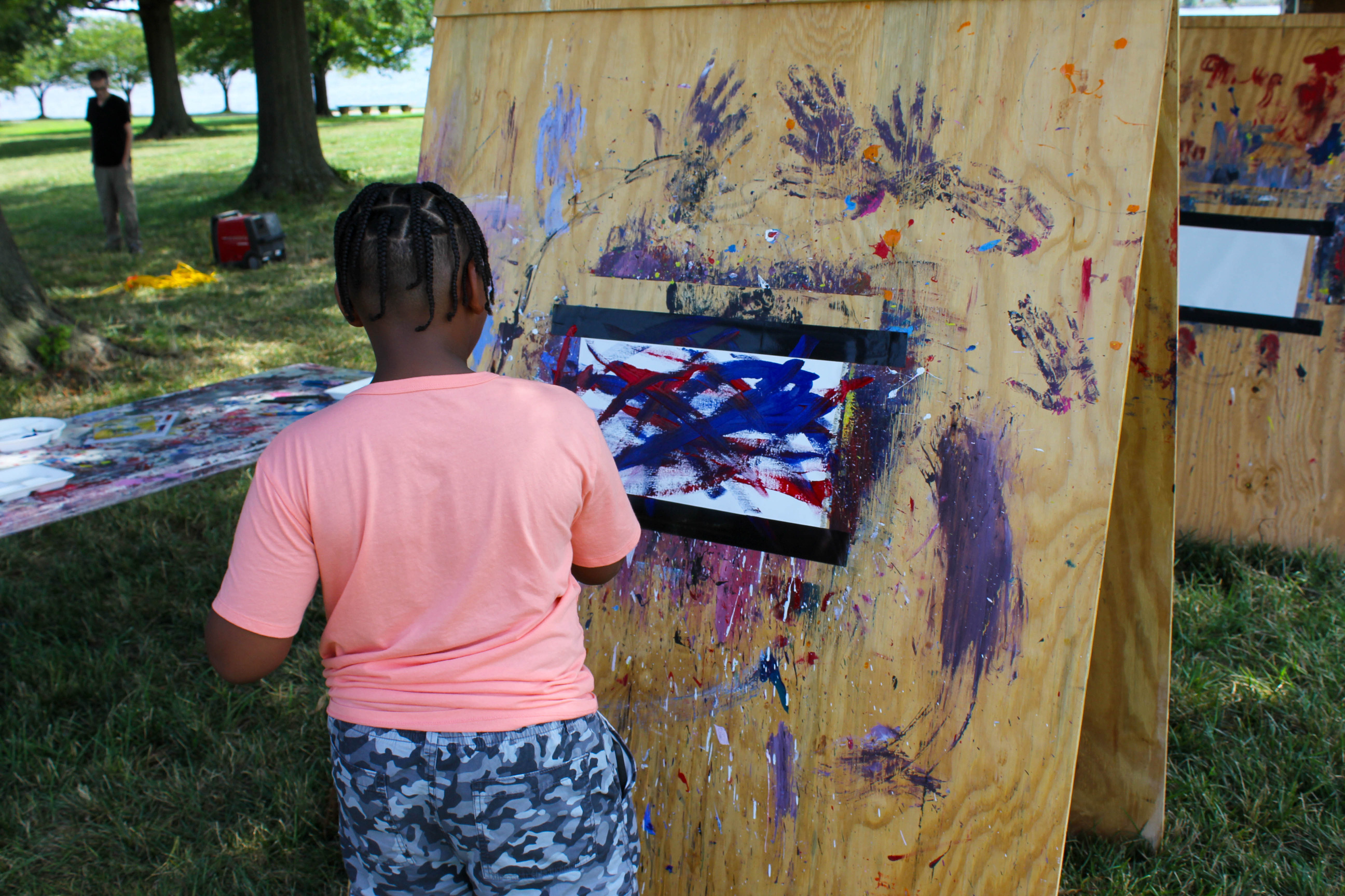 Child painting at their own paint stations