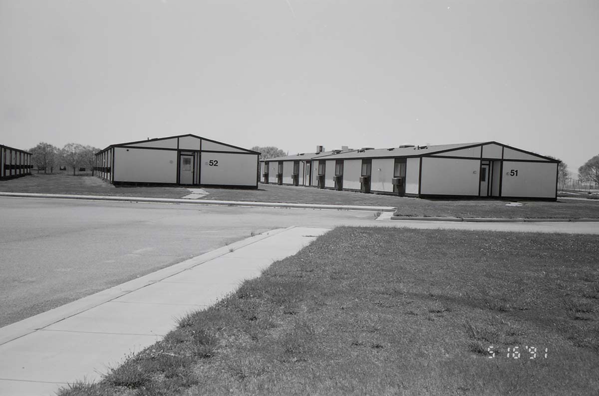 Barracks and parking area. Building numbers 51 and 52. [Image possibly for comparative housing study]