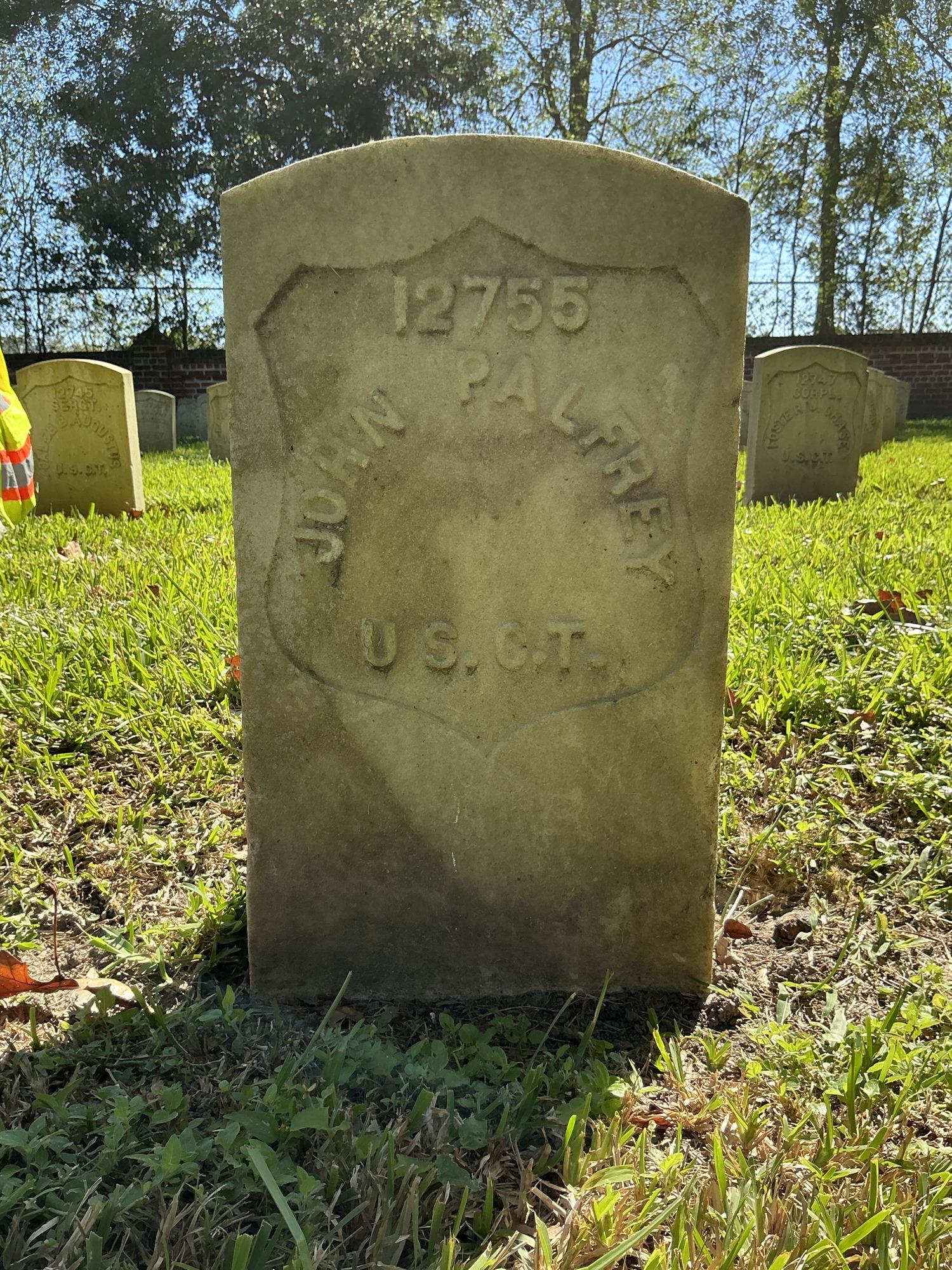 Front of historic upright marble headstone with recessed shield face.