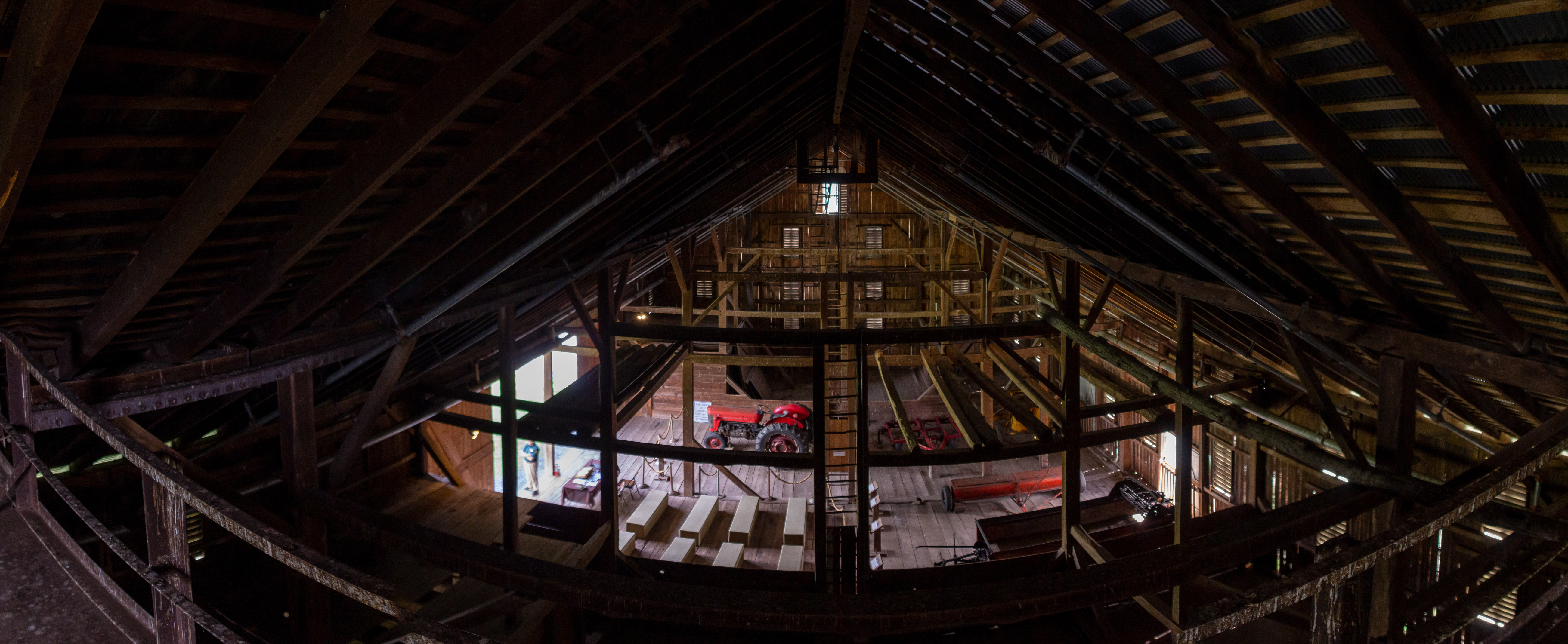 A barn with farm equipment inside from a birds eye view.
