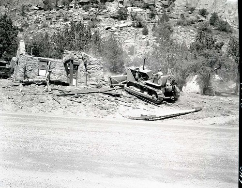 Realignment of Highway 1 - demolition of museum building with bulldozer.