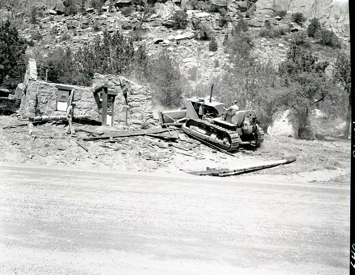 Realignment of Highway 1 - demolition of museum building with bulldozer.