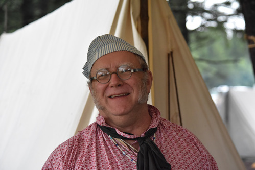 Reenactor wearing srtipped cap.