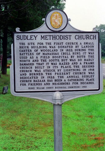 Sudley Methodist Church site signs at north entrance to park