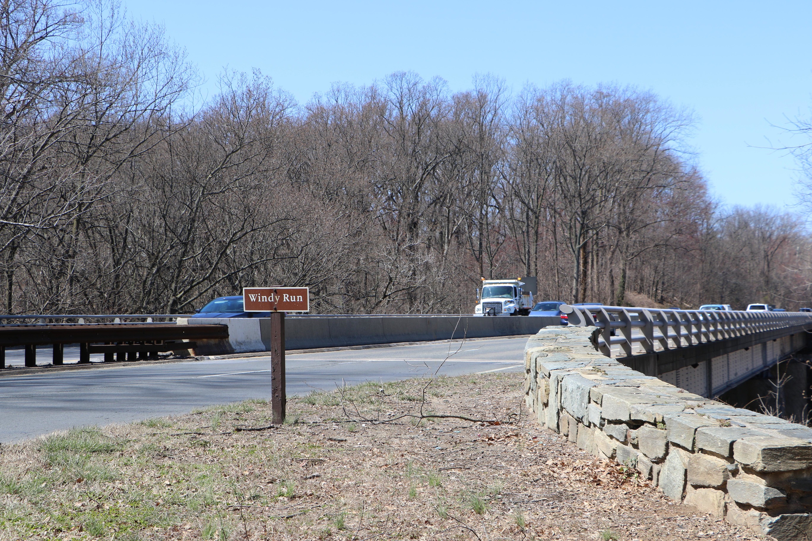 Sign marking Windy Run in front of bridge that carries George Washington Memorial Parkway.