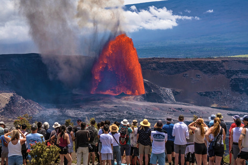 A crowd of visitors gathers to watch lava fountain and flow from two vents in the summit crater of Kīlauea volcano 