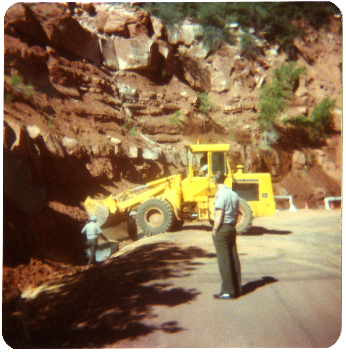 Tractor and men working on graveling/draining operations along the Zion-Mt. Carmel Highway switchbacks.