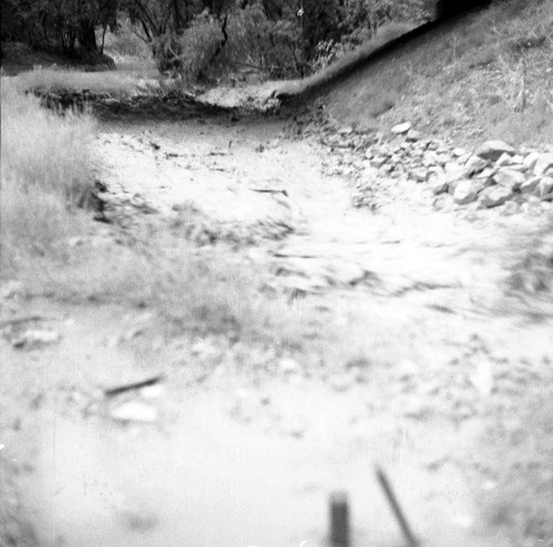 Flood damage from down pour - 1.38-inches in one hour high water in Oak Creek near bridge adjacent to Visitor Center employee's parking area.