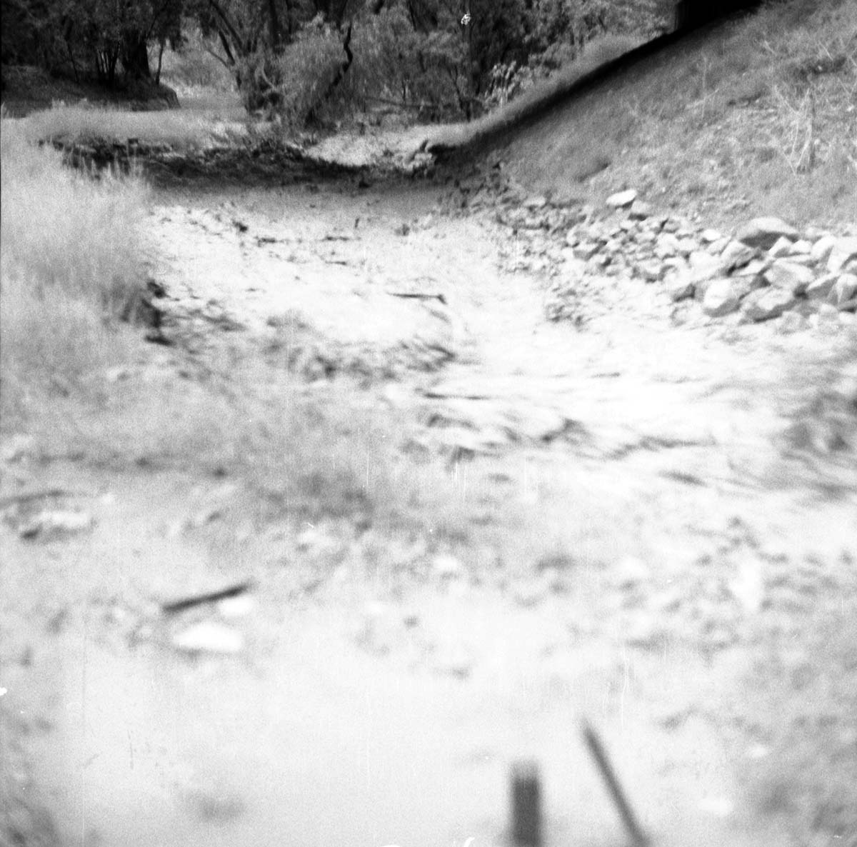 Flood damage from down pour - 1.38-inches in one hour high water in Oak Creek near bridge adjacent to Visitor Center employee's parking area.