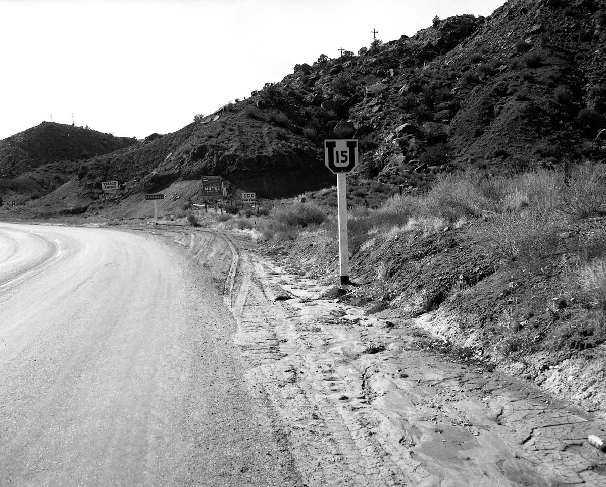 Roadside signs on State Route 15 (now State Route 9) in Springdale. Group of signs about 200 yards from South Entrance to park, across the highway from Zionville Market and Motel. Photographs for documentation for proposed clean up of undesirable signage and debris on the access route to Zion National Park.