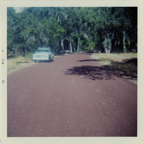 Road with construction vehicle pulled off to side during road repairs.