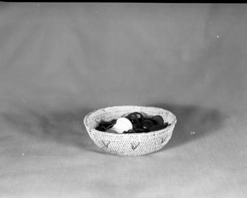 Private Collection. Object: Miwok basket. Dimensions: 7 x 2 1/4". Materials: Split bull pine and redbud. Technology: CLockspring start, overstitched, single rod interlocking, fag ends trimmed on workface, moving ends timmed on interior. Rim stitched around twice, splitting top coil. Collection History: Made by Matilda, a Sonora Miwok. Photographed by Michael Dixon. Catalogued by Craig Bates and Barbara Beroza. Yosemite Collections, National Park Service.