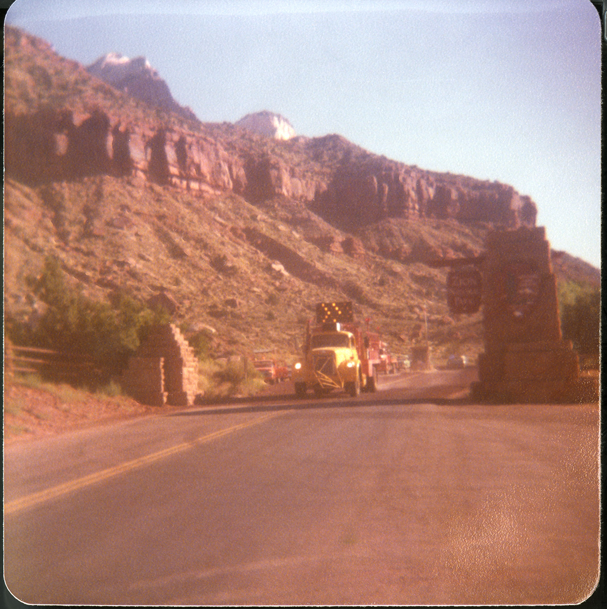 Construction vehicle working on road work at the south entrance of the park.