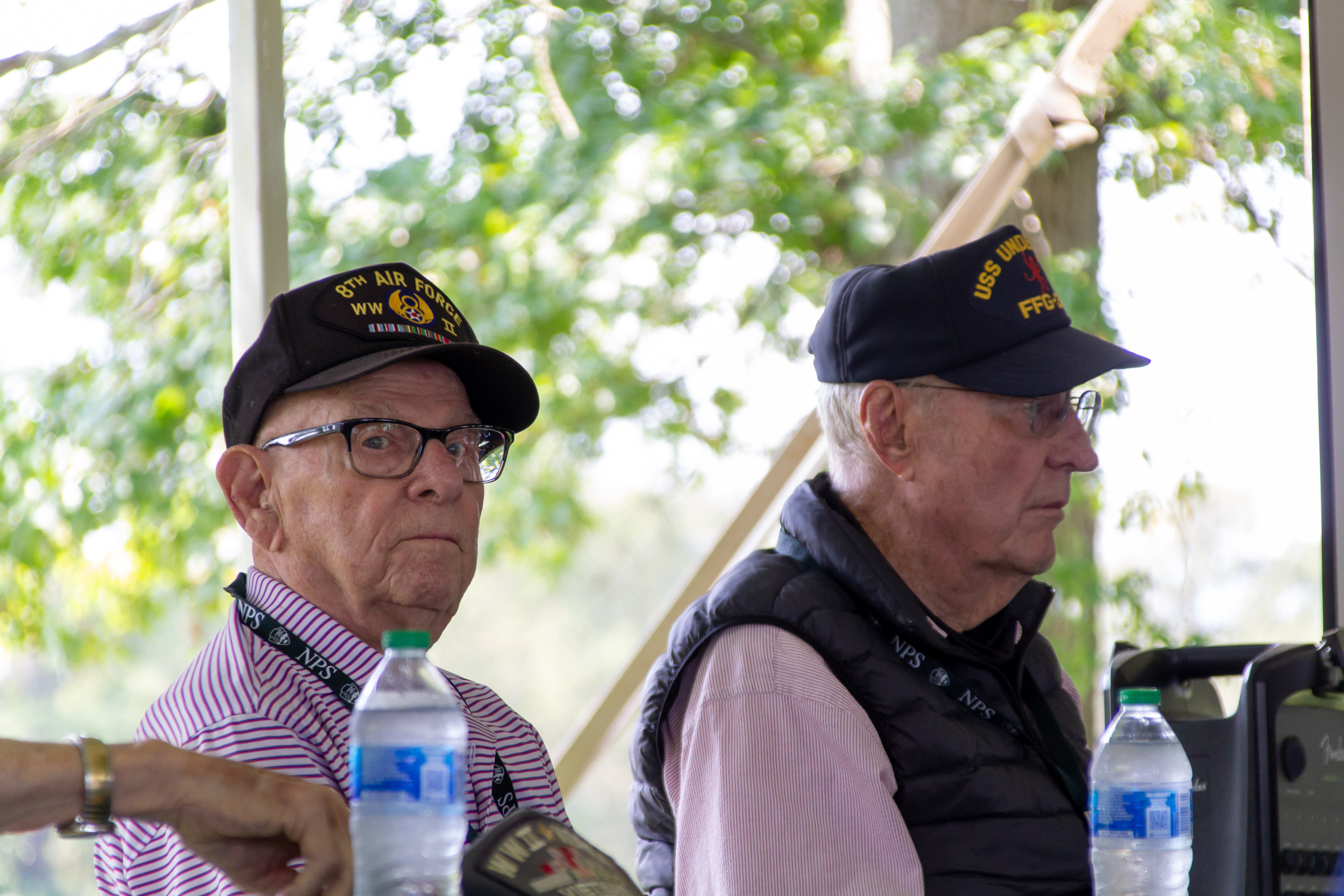Two World War 2 veterans sit at a table.
