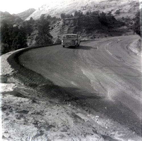 Truck driving down the road during east side road repair and turn out construction.