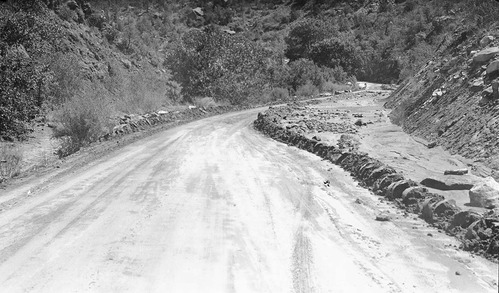 Flood damage of debris washed on to park road.