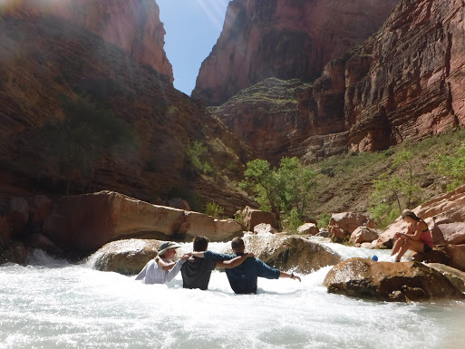 Three high school aged participants enjoying the waters of Havasu Creek in Grand Canyon.