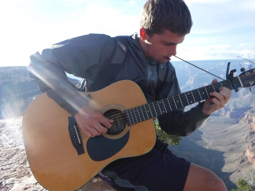 Youth Participant playing guitar on the South Rim of Grand Canyon. 