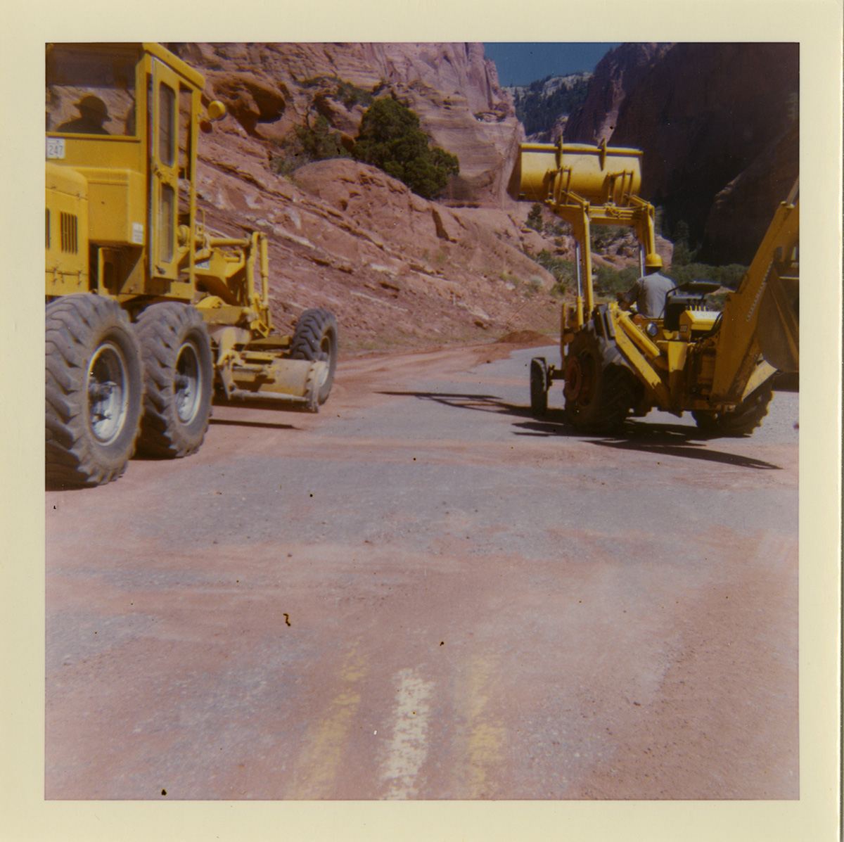 Tractors performing shoulder work along route 2 parking areas.