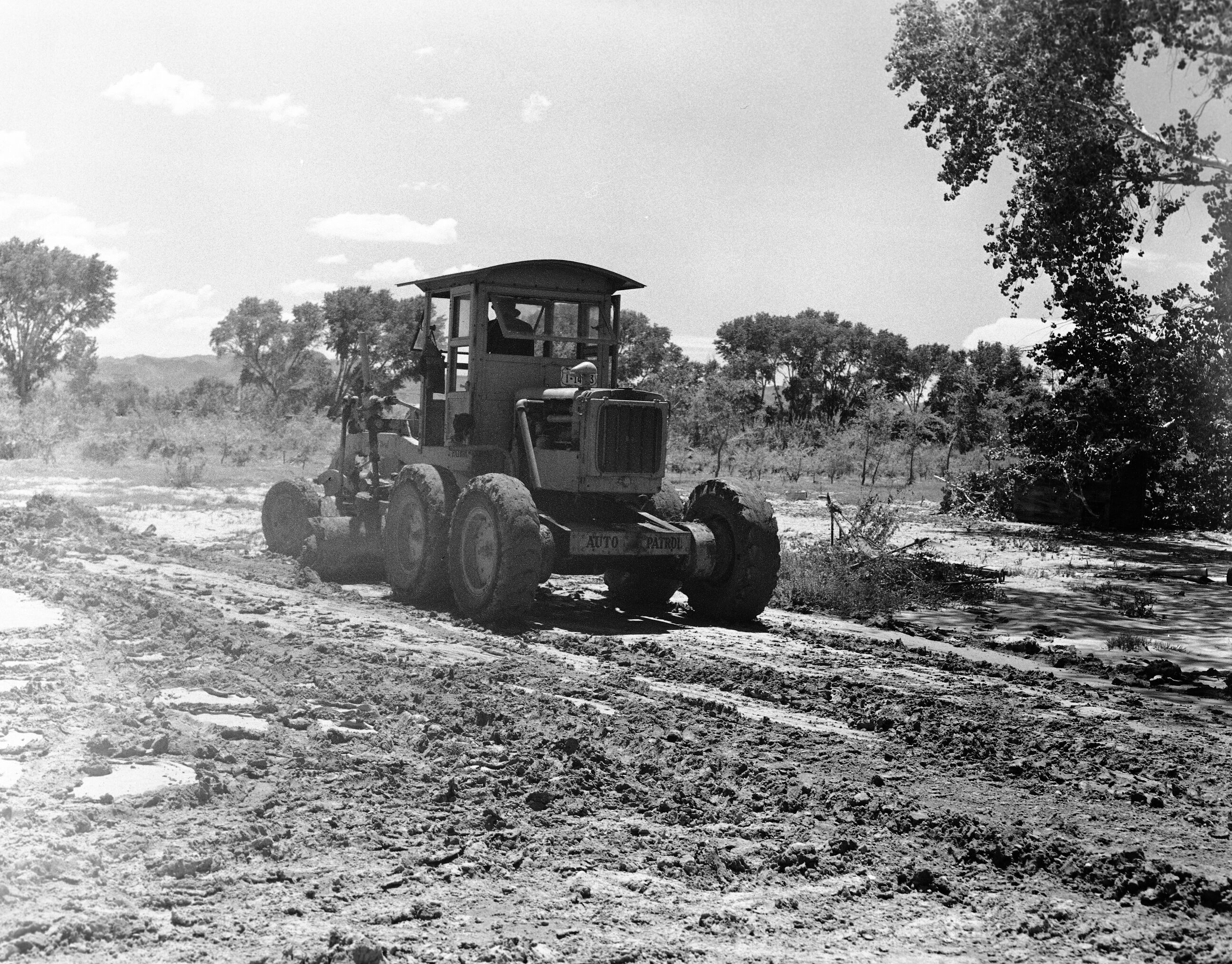 Motor patrol clearing off utility area after flood July 31, 1945