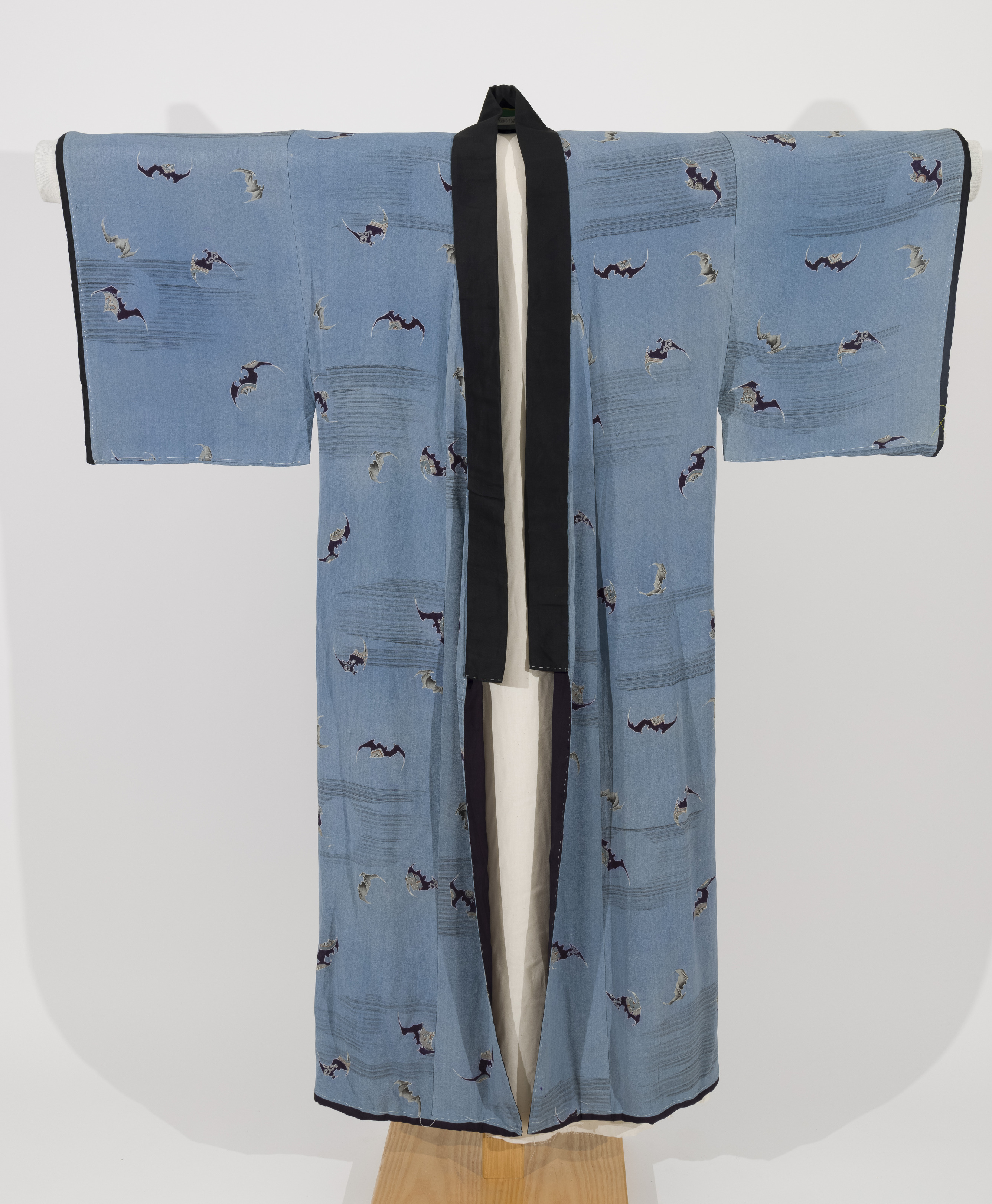 Blue, gray, and black silk crepe kimono with dark blue silk lining.  Design of bats, clouds and full moons.  Black collar and lapels.