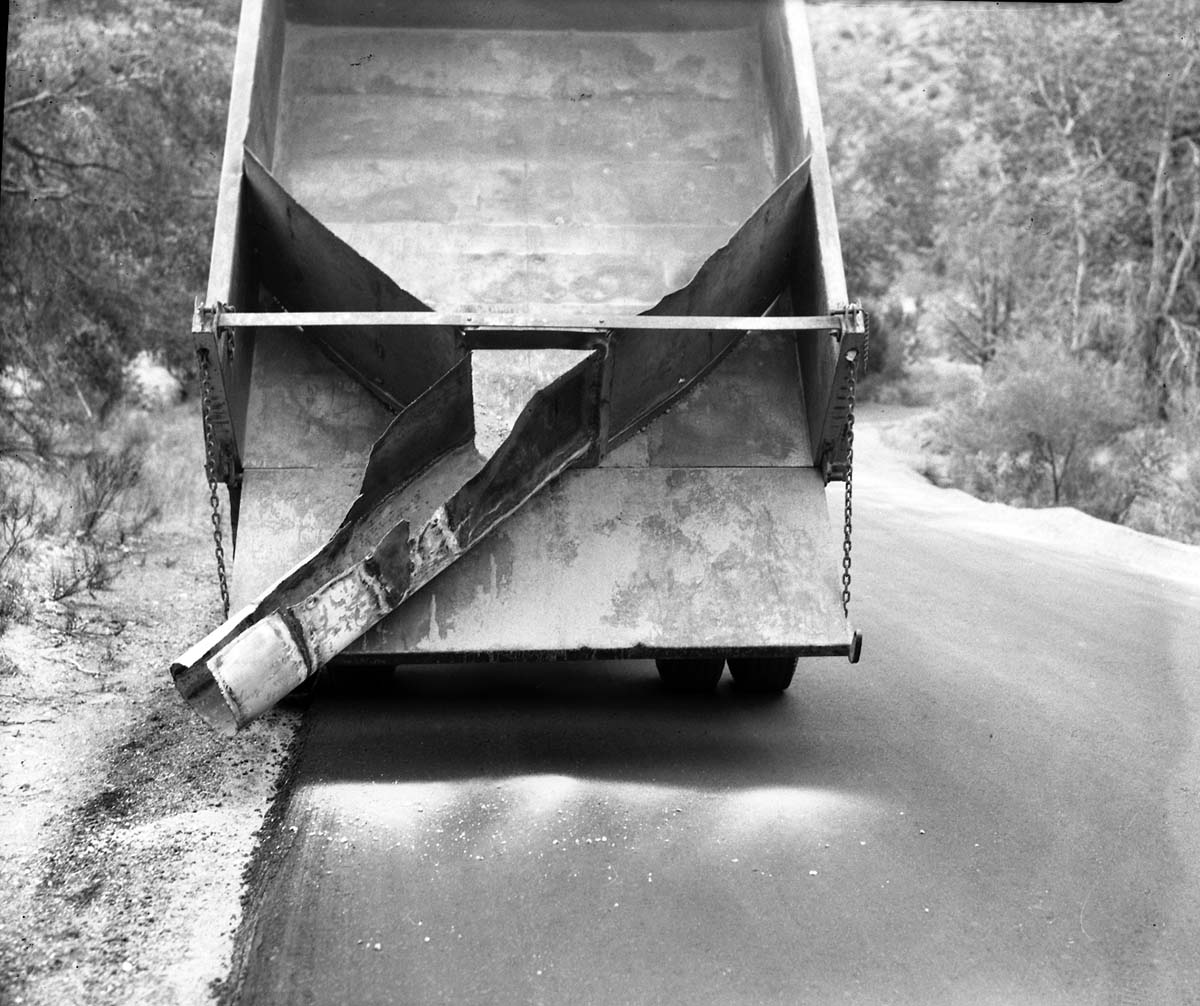 Road maintenance - truck bed and chute of gravel spreader dump truck, truck bed fully raised.