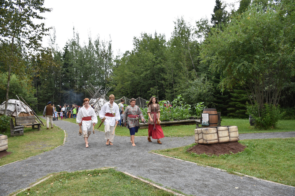 Reenactors walking on a path.