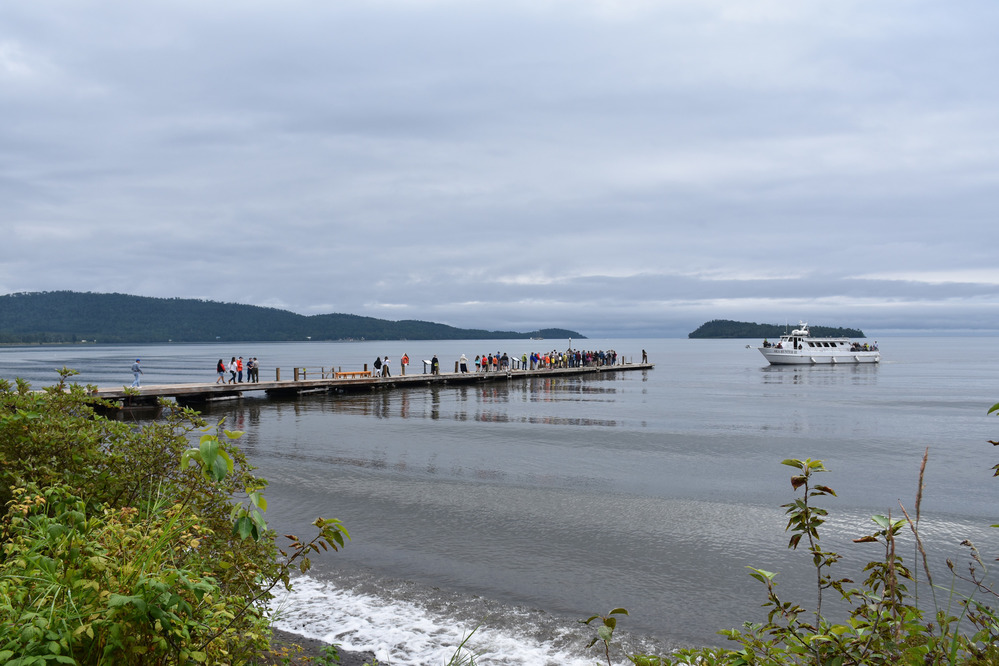 People lined up on the dock as Voyageur arrives