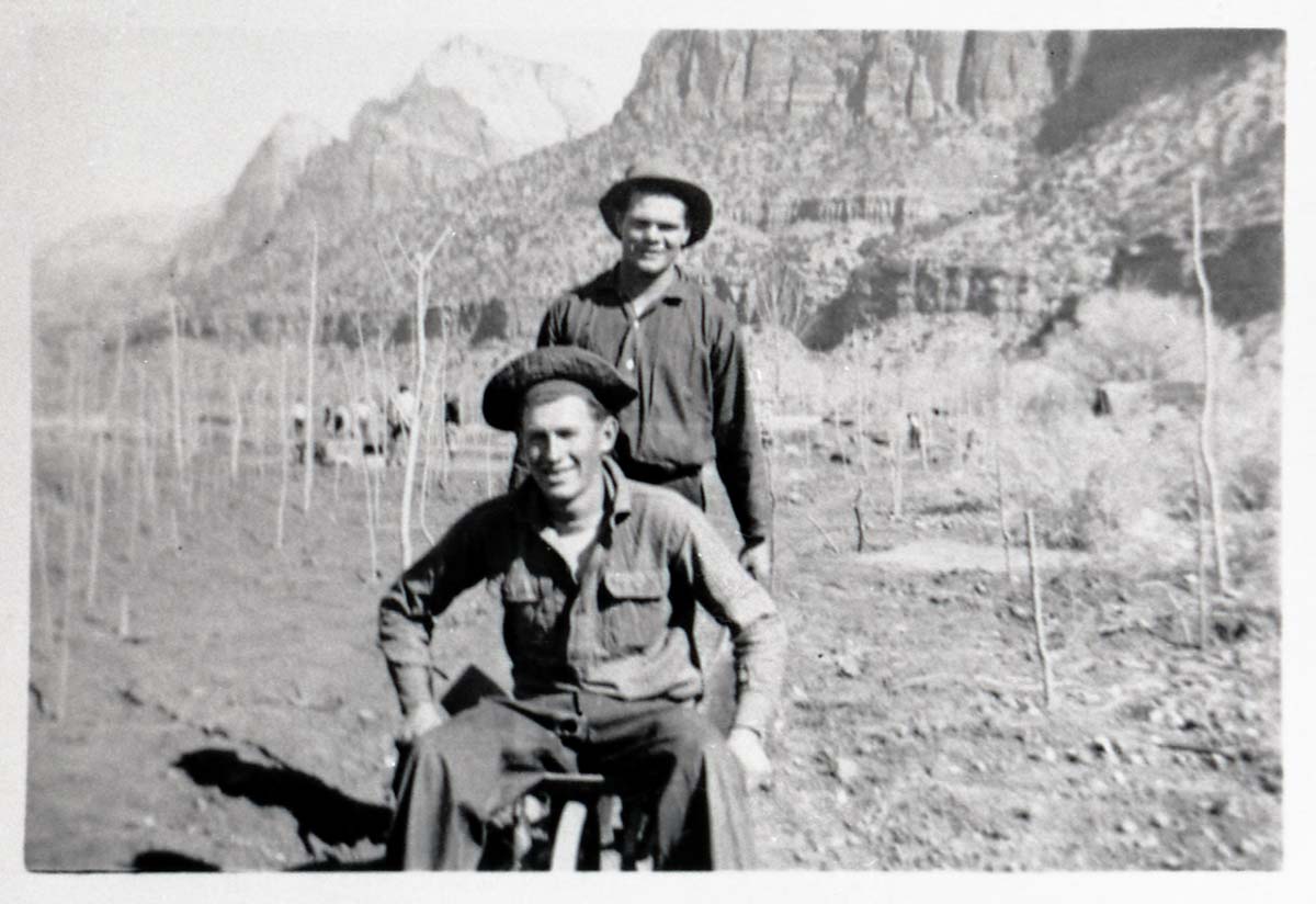 Two Civilian Conservation Corps (CCC) men riding in wheel barrow near the South Entrance.