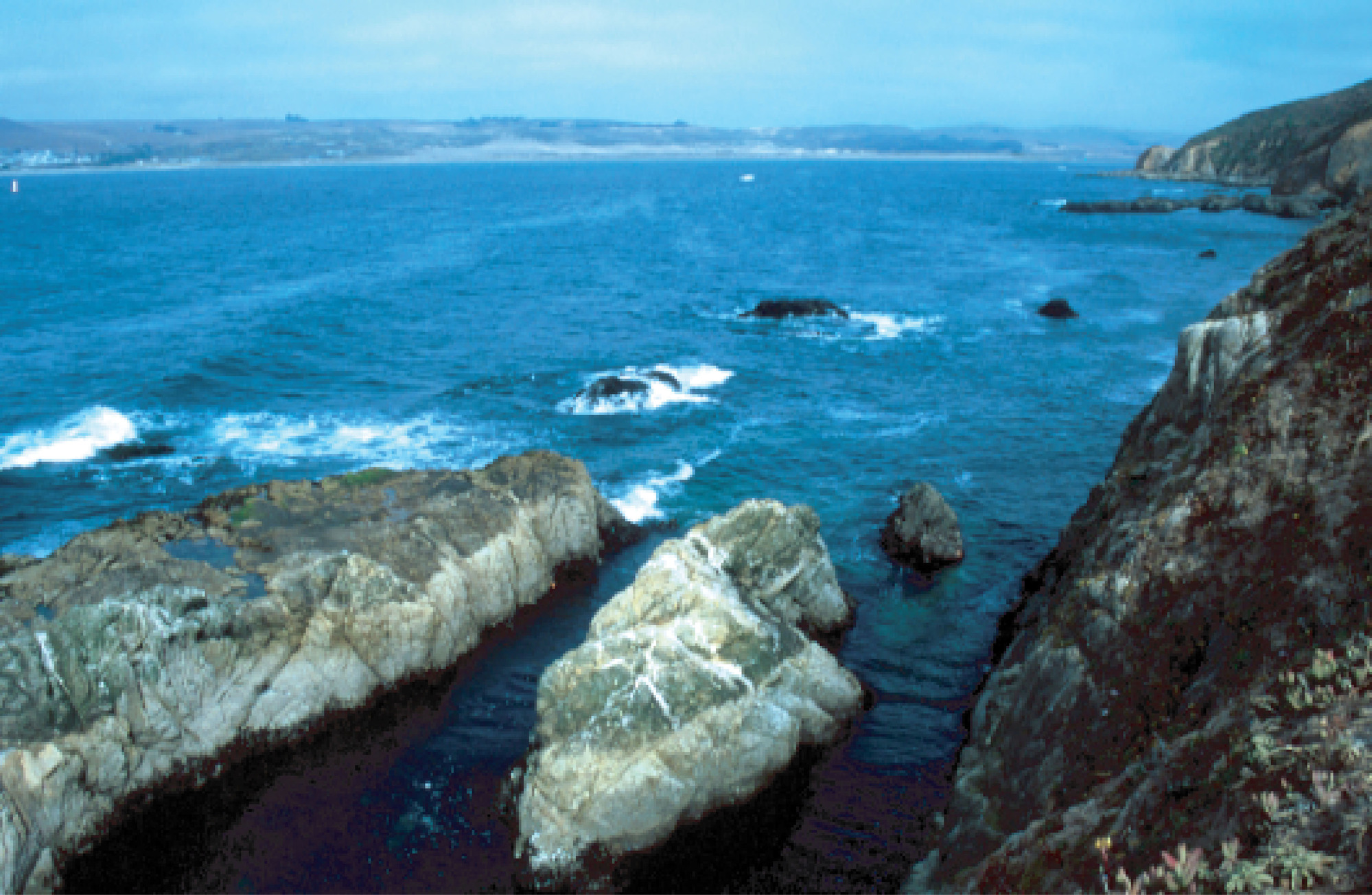 rocky shoreline and open water bay