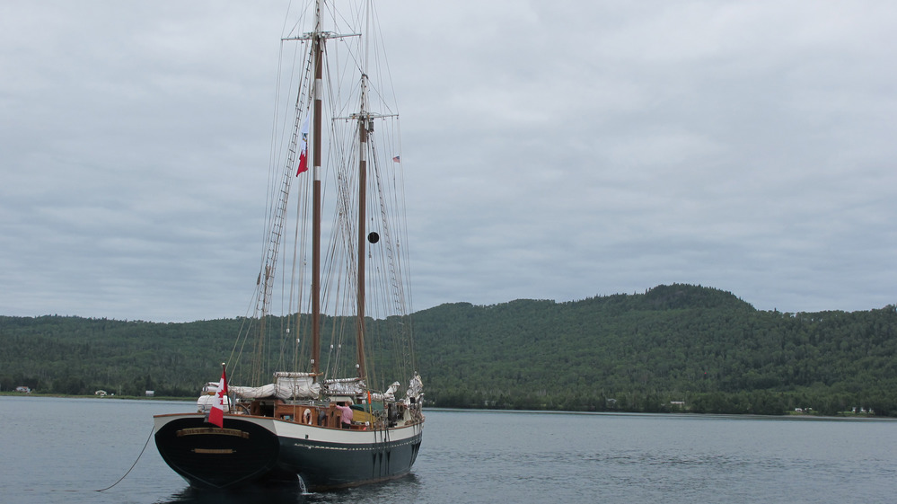 Nountain behind schooner at anchor.