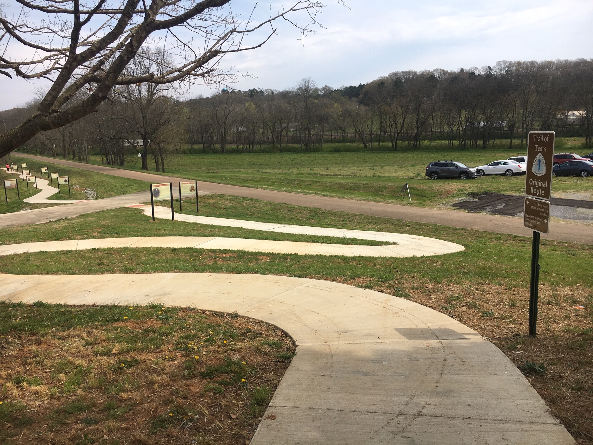 A paved path leading a grassy area.