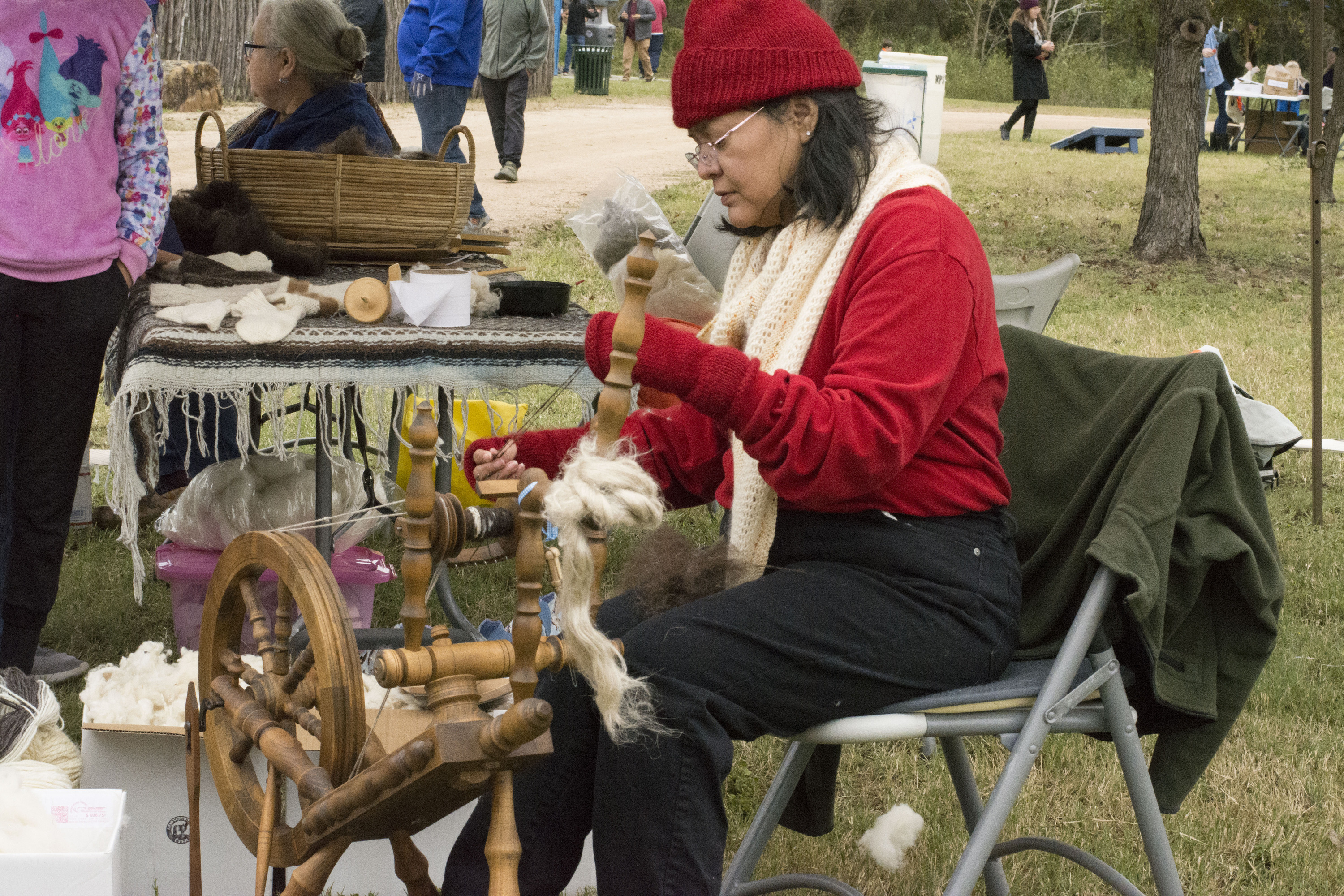Woman spinning wool into yarn.
