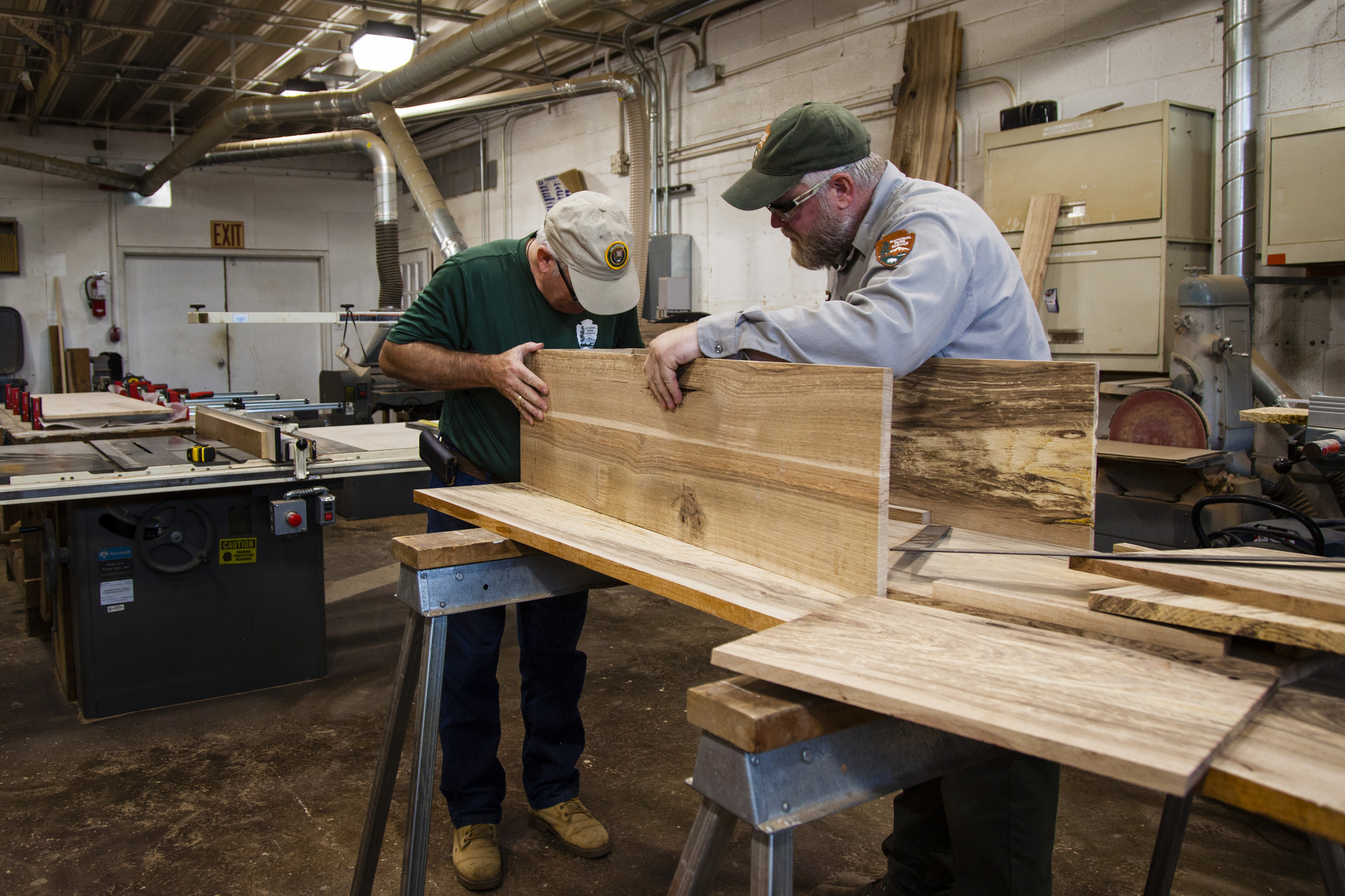 Two men work together to form the shape of the toe-pincher style coffins. 
