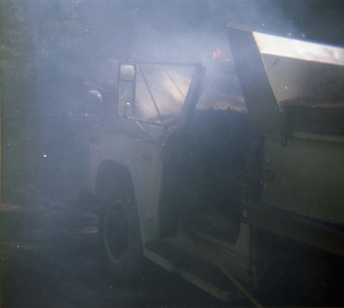 Color photo of an engine fire in a pickup.