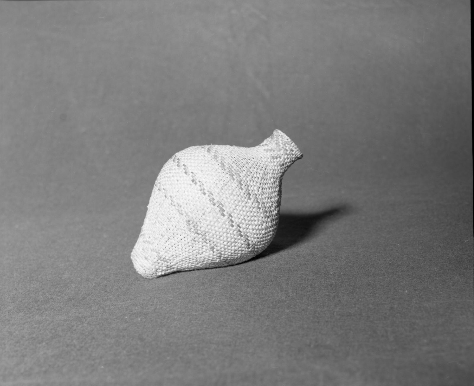 Mrs. Donald Segerstrom Collection. Object: Model Paiute jug. Dimensions: 7" height. Materials: willow, commercially-dyed willow. Technology: two ply, Z-twist hemp cordage; three strand twined start, rest of basket in diagonal twining. Collection History: ---. Photographed of Michael Dixon, 1/83. Catalogued by Craig Bates and Barbara Beroza. Yosemite Collections, National Park Service.