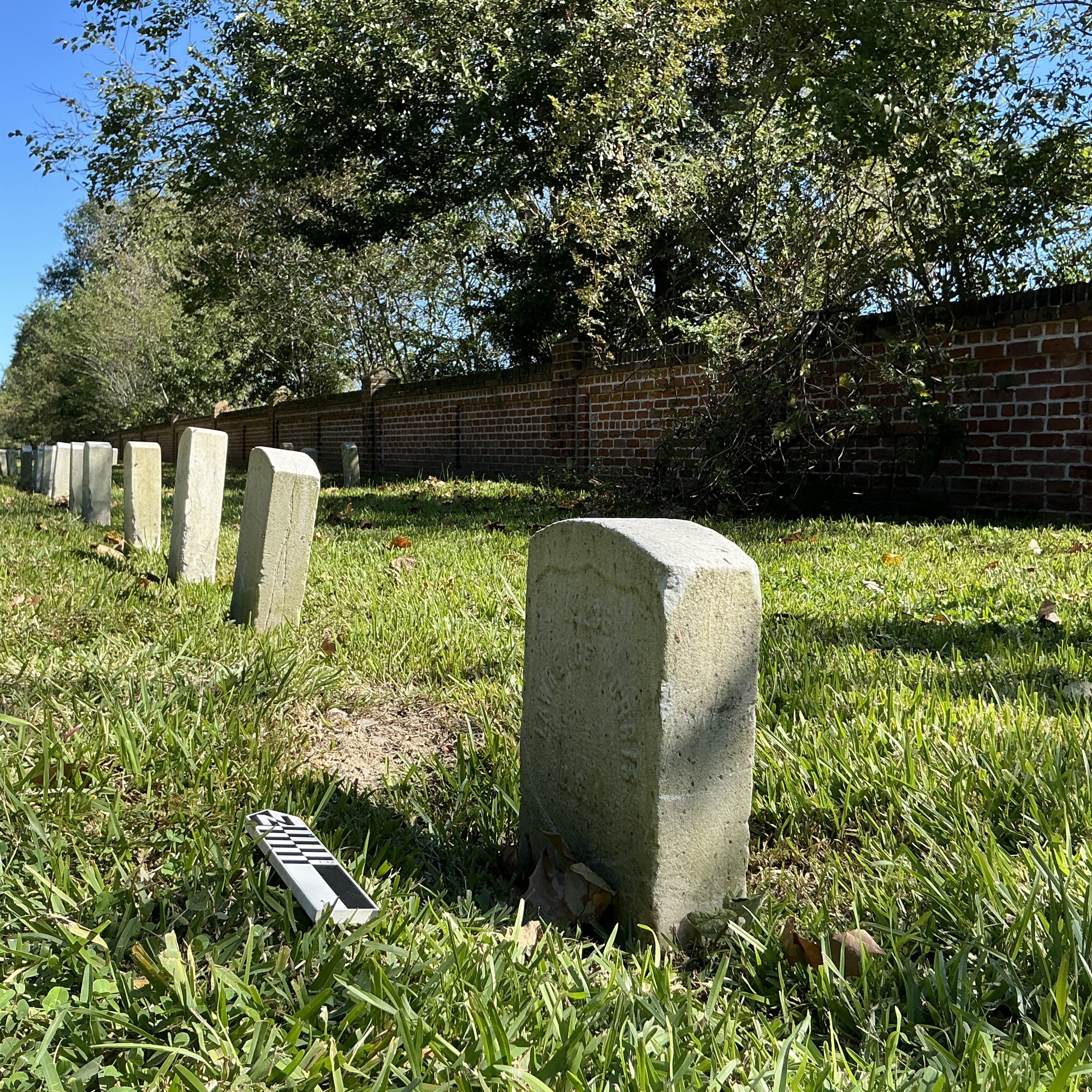 Extra image of historic upright marble headstone with recessed shield face.