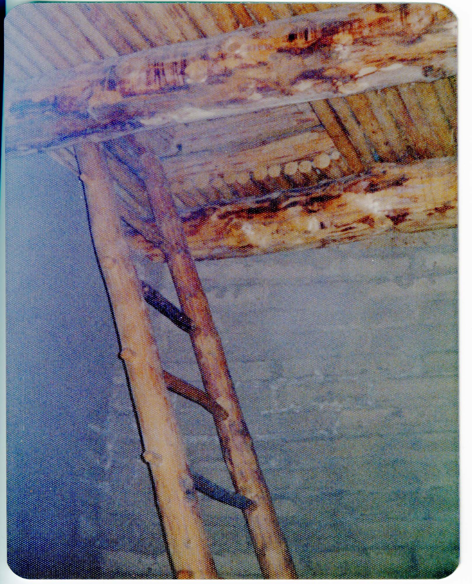 A wooden ladder leads to a hatch in the floor of the tower. 